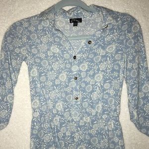 Blue mid-length sleeve romper with white flowers.